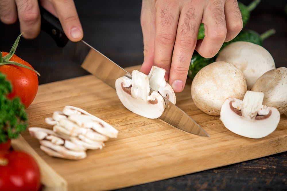 Chopping fresh mushrooms