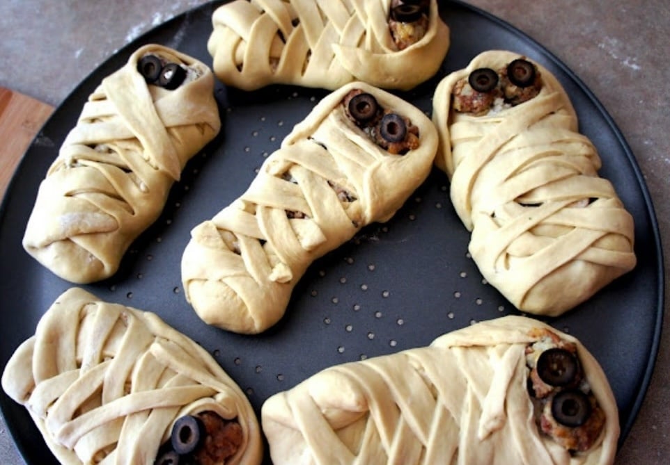 plate of calzones shaped to look like mummies