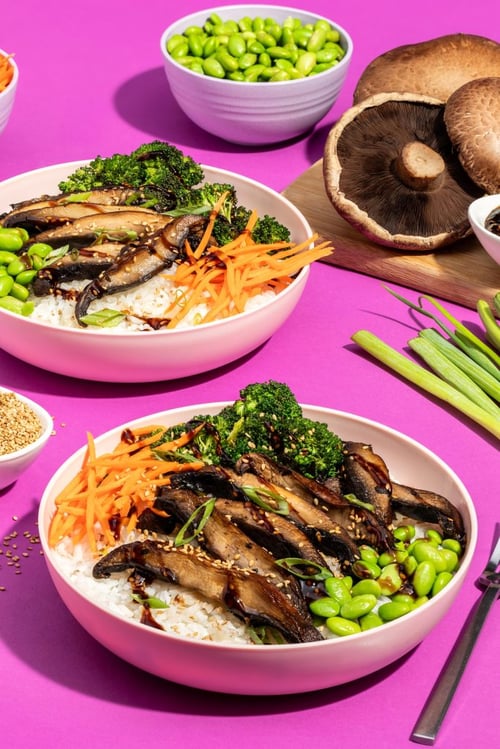 Mushroom rice bowl with carrots, broccoli, edamame in a white bowl with green onions on the side